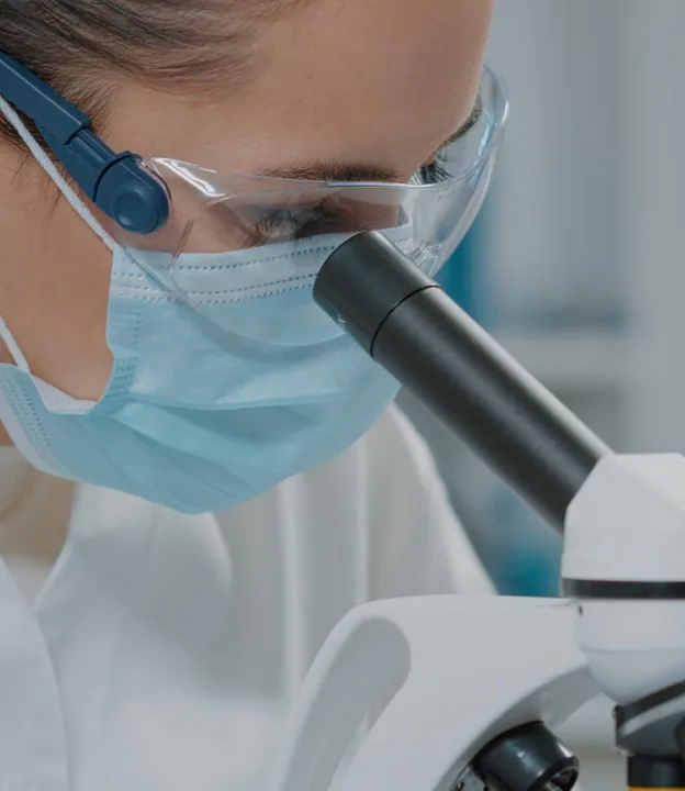 A scientist at a microscope